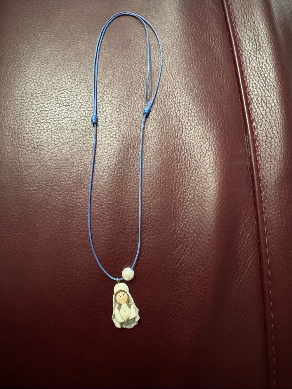 Source Unknown Blue Cord Necklace with Cream Religious Pendant